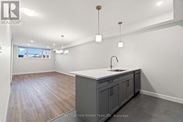 The Nation fourplex for rent - A kitchen with a sink and cabinets.