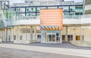 Vaughan (Concord) condo for rent - The image shows the front of a realty office with a glass facade and a large orange signboard.