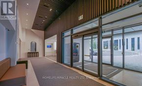 Richmond Hill (South Richvale) condo for rent - A hallway with a glass door leading to a parking lot.
