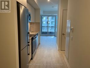 Richmond Hill (South Richvale) condo for rent - A kitchen with a refrigerator, sink, and stove.