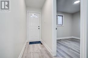 Toronto (Pleasant View) apartment for rent - A white door is in a room with a window and a mat on the floor.