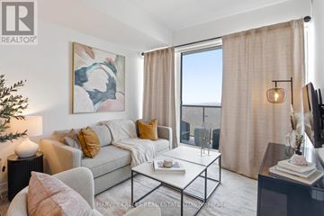 Toronto (Crescent Town) condo for rent - A living room with a grey couch, a coffee table, and a painting on the wall.