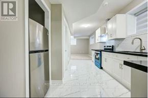 Kitchener apartment for rent - A kitchen with white cabinets and a marble floor.