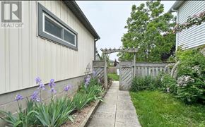 Clarington (Courtice) apartment for rent - A realtor photo of a house with a grey siding and a white window.