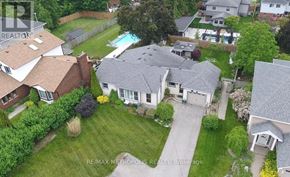 Clarington (Courtice) apartment for rent - A bird's eye view of a residential area with houses and a swimming pool.