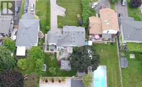 Clarington (Courtice) apartment for rent - A bird's eye view of a residential area with houses and a swimming pool.