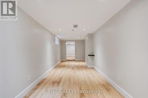 London East (East M) apartment for rent - A long, empty hallway with wooden floors and white walls.