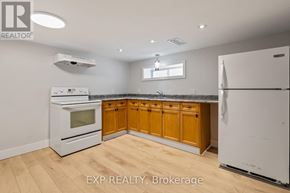 London East (East M) apartment for rent - A kitchen with wooden cabinets and white appliances.