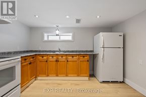 London East (East M) apartment for rent - A kitchen with wooden cabinets and a white refrigerator.