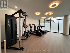 Ottawa condo for rent - A gym with a row of treadmills and a weight machine.