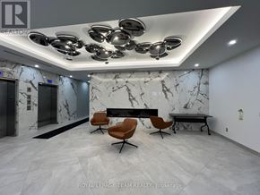 Ottawa condo for rent - A modern office lobby with marble walls and a bench.