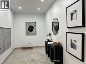 Ottawa condo for rent - A room with a white wall and a framed picture hanging on it.
