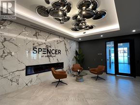 Ottawa condo for rent - A modern office lobby with a marble floor and a Spencer sign on the wall.