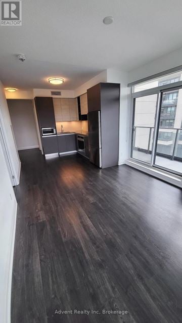 Richmond Hill (Doncrest) condo for rent - A kitchen with dark wood floors and a large window.
