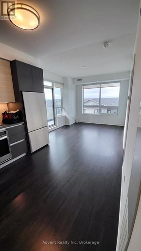 Richmond Hill (Doncrest) condo for rent - A spacious kitchen with dark wood floors and white cabinetry.