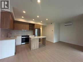 New Westminster apartment for rent - A modern kitchen with wooden cabinets and a white countertop.