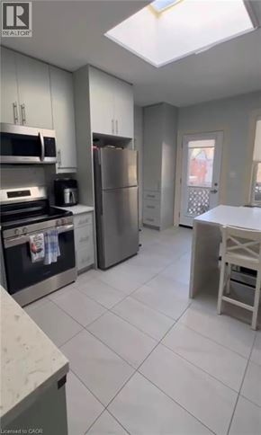 Hamilton apartment for rent - A kitchen with white cabinets and a refrigerator.