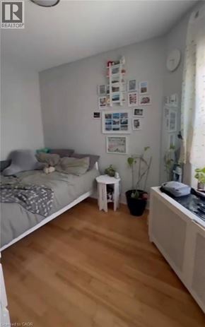Hamilton apartment for rent - A bedroom with a bed, a small table, and a radiator.