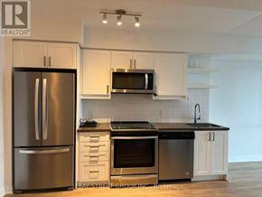 Toronto (Church-Yonge Corridor) condo for rent - A modern kitchen with white cabinets and stainless steel appliances.