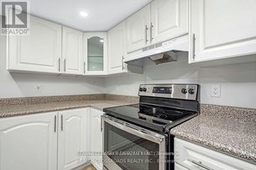Ottawa apartment for rent - A kitchen with white cabinets and a granite countertop.