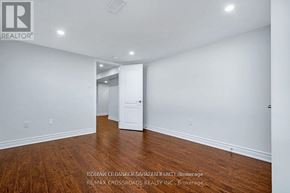 Ottawa apartment for rent - A spacious room with wooden floors and white walls, ready for staging.