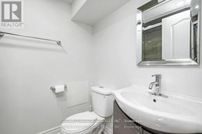 Ottawa apartment for rent - A white toilet and sink in a small bathroom.