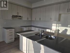 Clarington (Courtice) apartment for rent - A kitchen with a sink and cabinets.