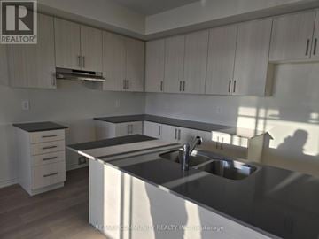 Clarington (Courtice) apartment for rent - A kitchen with a sink and cabinets.