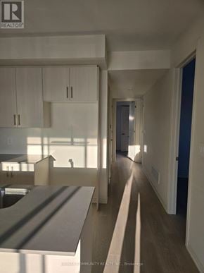 Clarington (Courtice) apartment for rent - A realtor photo of a modern kitchen and hallway.