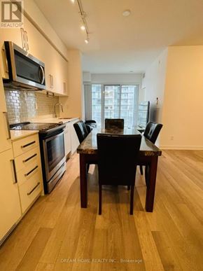 Toronto (Willowdale West) condo for rent - A kitchen with a table and chairs in front of a window.