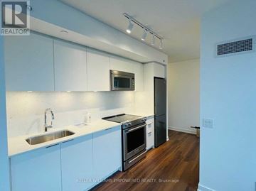 Toronto (Islington-City Centre West) condo for rent - A modern kitchen with white cabinets and stainless steel appliances.