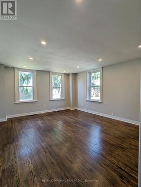 Kawartha Lakes (Lindsay) multi-family for rent - A room with wooden floors and three windows.