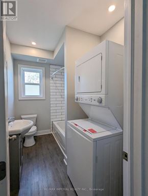 Kawartha Lakes (Lindsay) multi-family for rent - A bathroom with a toilet, sink, and a window.