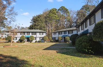 Decatur apartment for rent - A row of houses with green trees in front.