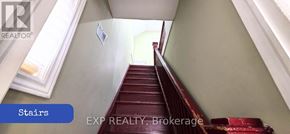 Toronto (Brookhaven-Amesbury) apartment for rent - A staircase with a blue sign that says "Stairs" on the bottom left.