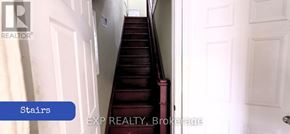 Toronto (Brookhaven-Amesbury) apartment for rent - A staircase with a red carpet and white walls.