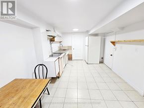 Toronto (Milliken) apartment for rent - A white room with a table and chairs in it.