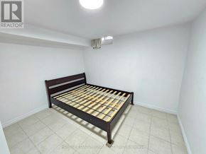 Toronto (Milliken) apartment for rent - A bedroom with a bed and a ceiling light.