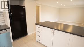St. Catharines apartment for rent - A kitchen with white cabinets and a black countertop.