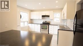 St. Catharines apartment for rent - A modern kitchen with a black countertop and stainless steel appliances.
