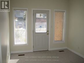 Toronto (Alderwood) multi-family for rent - A room with a door, a window with blinds, and a window without blinds.