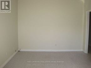 Toronto (Alderwood) multi-family for rent - A room with a carpet floor and a wall with a logo that says REALTOR.