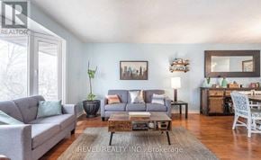 Haldimand apartment for rent - A living room with a grey couch, a coffee table, and a mirror on the wall.