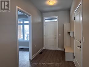 Brockville townhouse for rent - A room with a door, a window, and a bench.