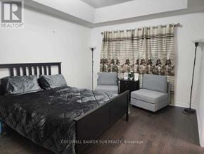 Whitby (Lynde Creek) apartment for rent - A bedroom with a bed, chair, and lamp.