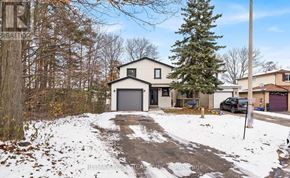 Barrie (Allandale Heights) apartment for rent - A house with a garage is surrounded by snow and trees.