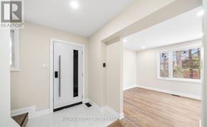Barrie (Allandale Heights) apartment for rent - A room with a white door and a window with a view of trees outside.