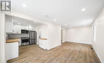 Barrie (Allandale Heights) apartment for rent - A spacious kitchen with white cabinets and a wooden countertop.