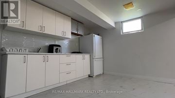 Toronto (Elms-Old Rexdale) apartment for rent - A white kitchen with a refrigerator and cabinets.