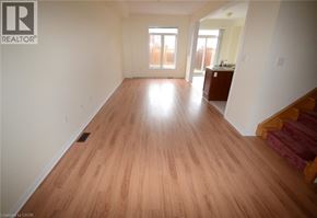 Mississauga townhouse for rent - A room with wooden flooring and a staircase on the right side.
